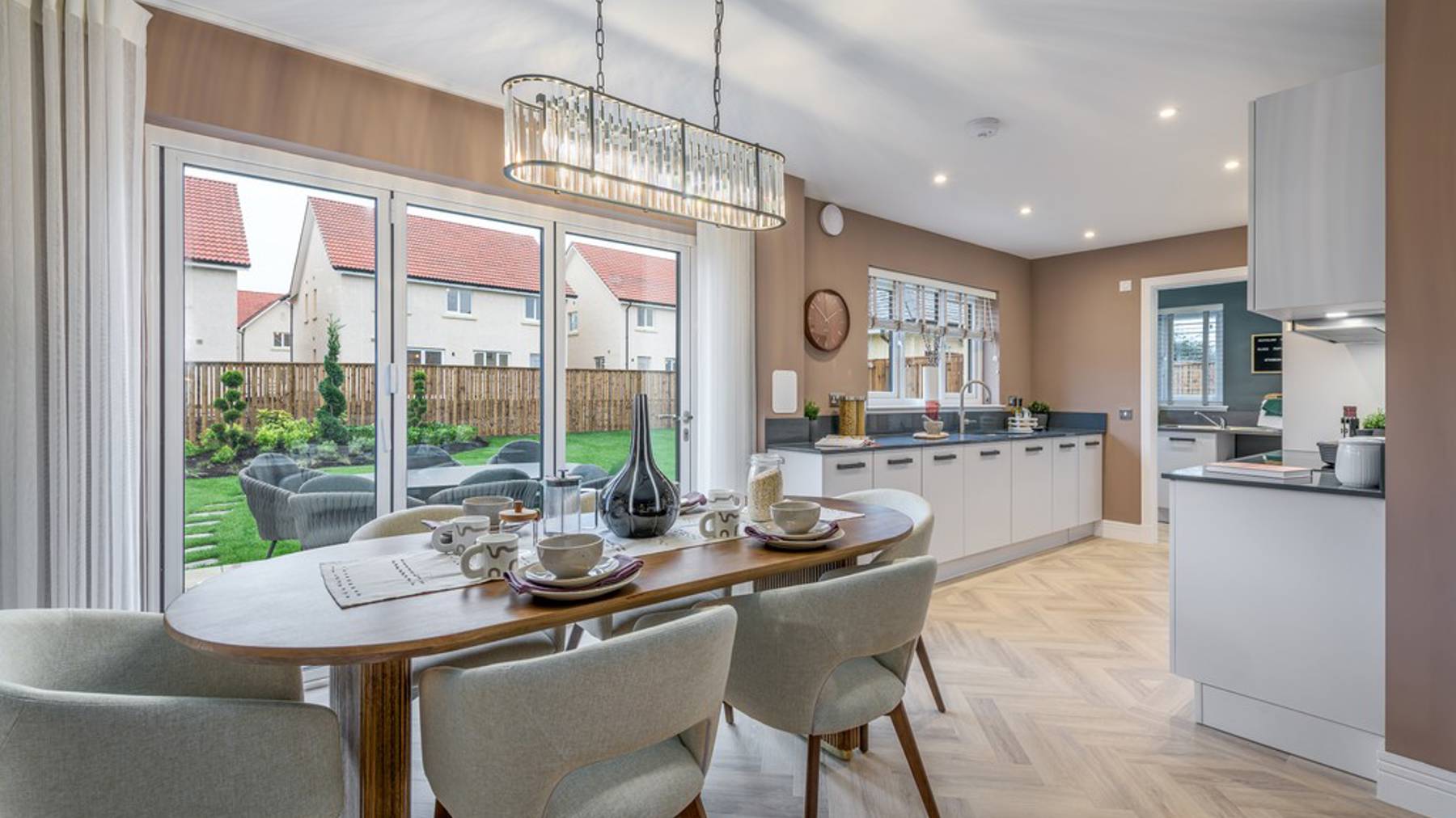 4 bedroom showhome | open plan high spec kitchen and dining area with bi-fold doors to the garden