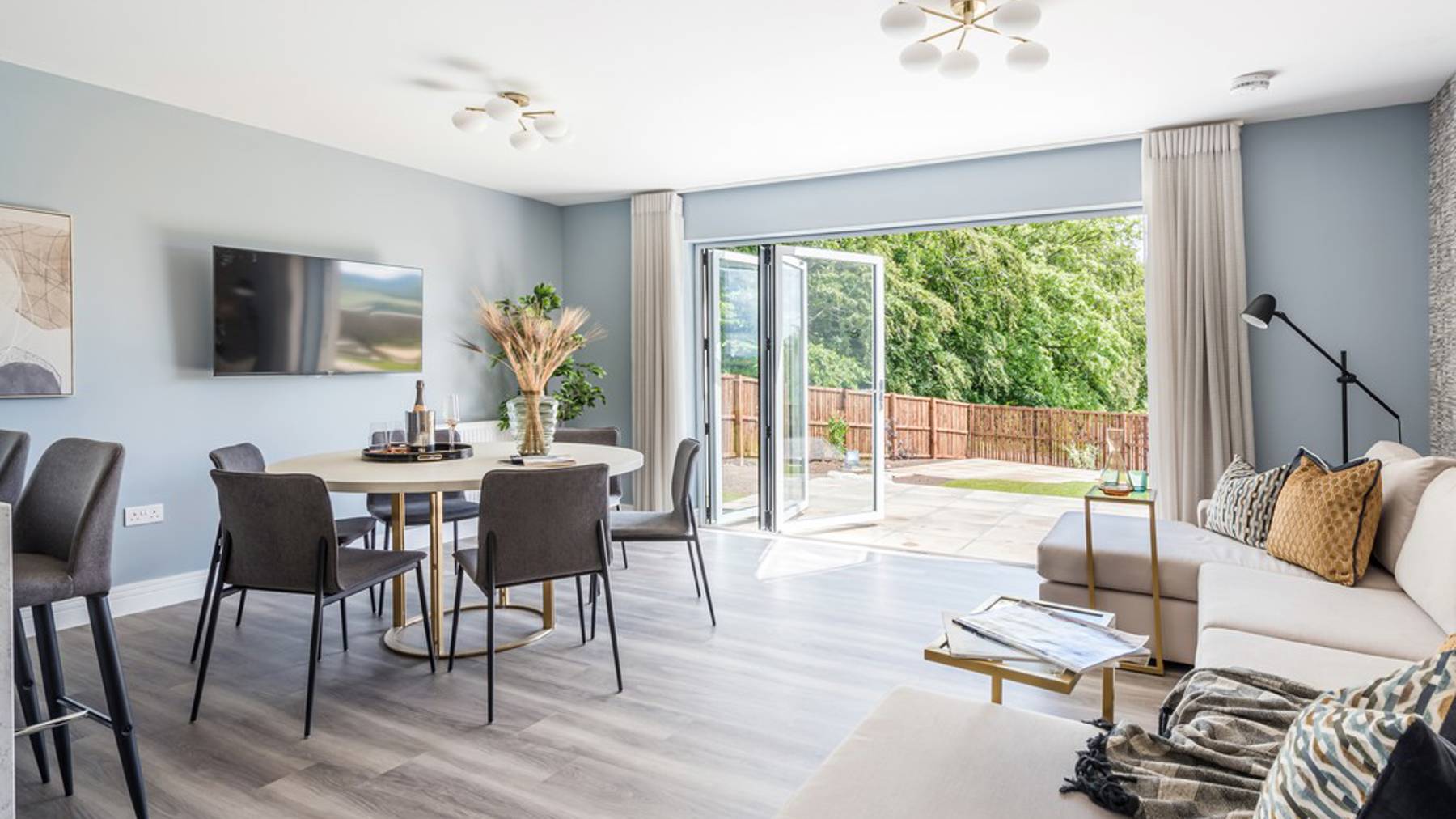 Open plan dining and family area with bifold doors into garden