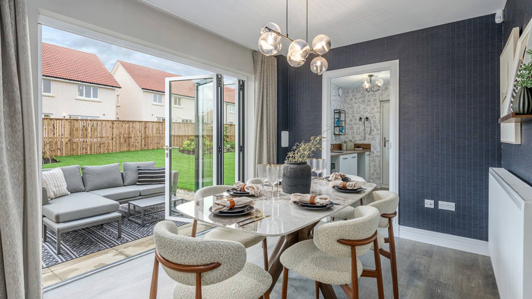 4 bedroom showhome | open plan kitchen and dining area with bi-fold doors opening to rear garden