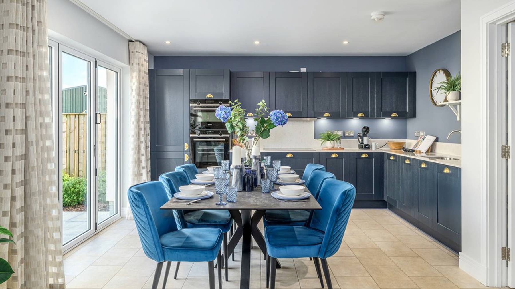 5 bedroom showhome | expansive open plan kitchen, dining and family area with bi-fold doors to rear garden