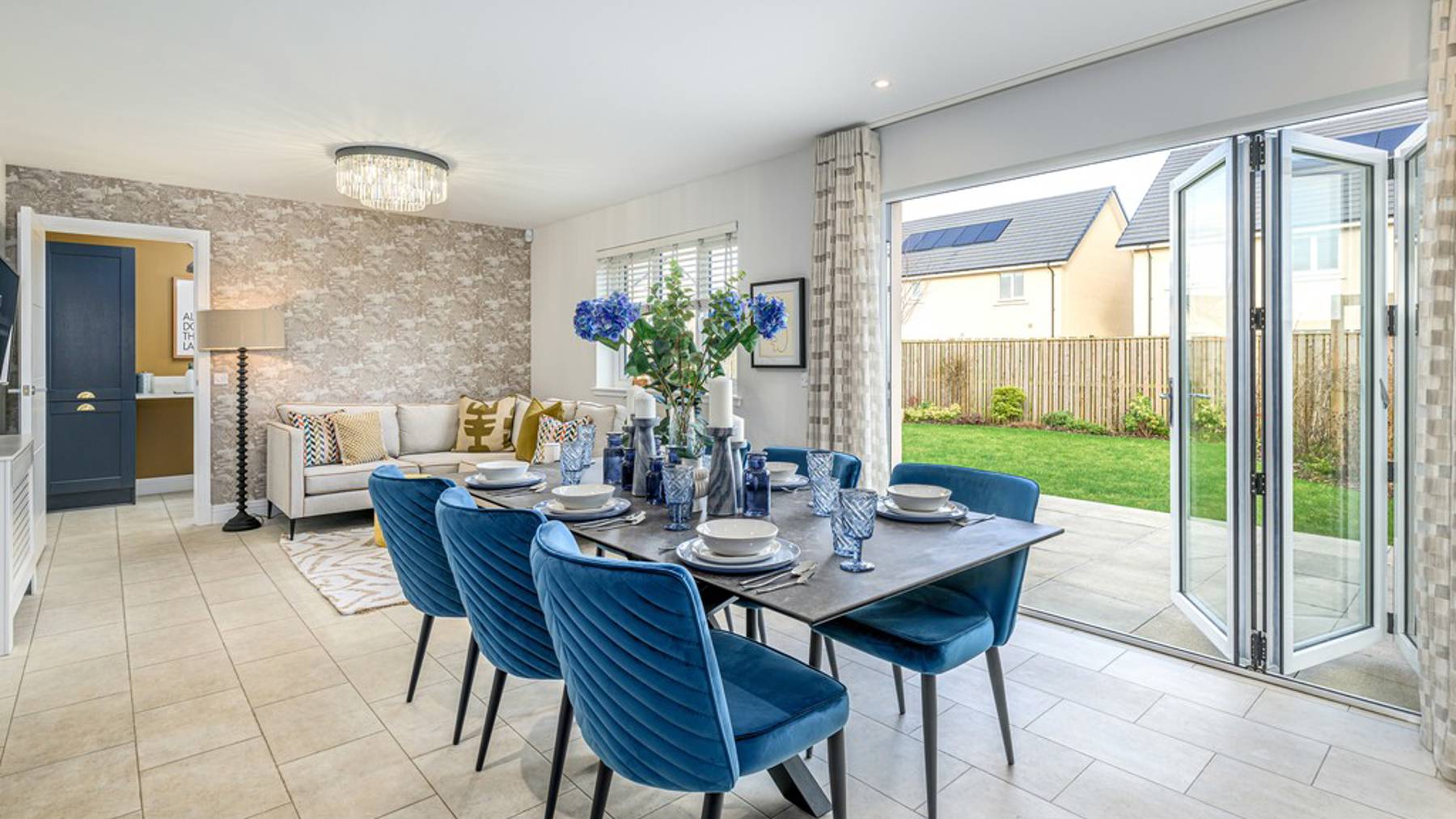 Open plan dining and family area with bifold doors into garden