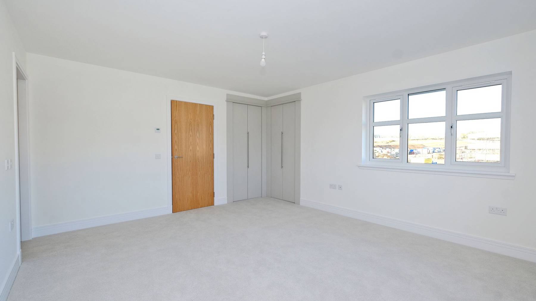 Large bedroom with built in wardrobes 